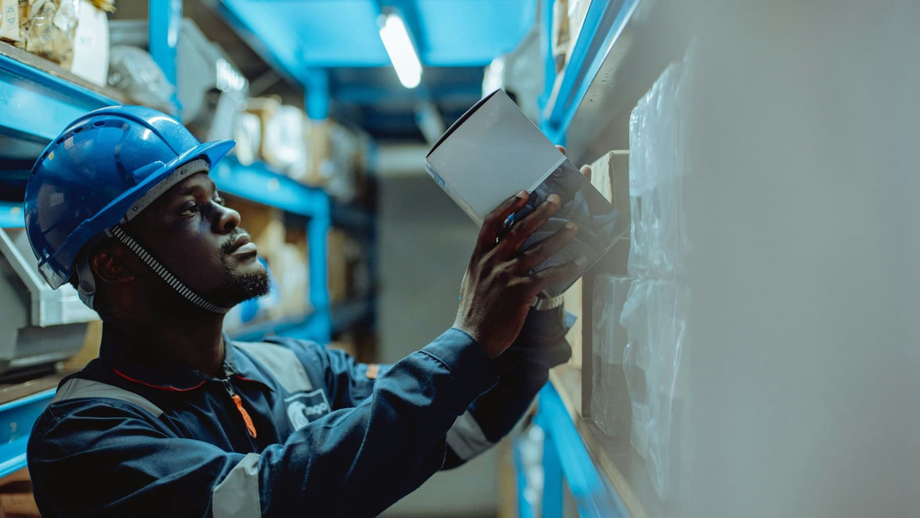 Warehouse worker scanning a shelf during order fulfillment